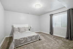 Bedroom featuring baseboards and carpet floors
