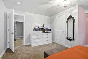 Bedroom with light carpet and baseboards