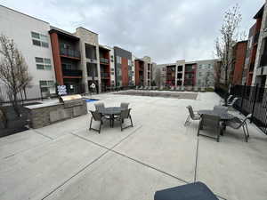 View of patio with outdoor dining area and area for grilling