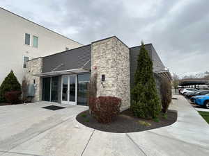 View of side of property with stone siding and french doors