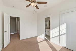 Empty room with light carpet and ceiling fan