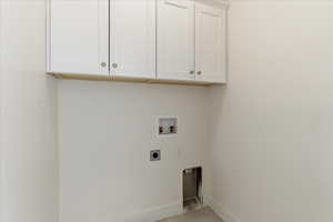 Laundry area with hookup for an electric dryer, washer hookup, and cabinet space