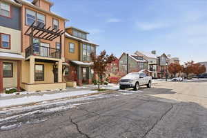 View of asphalt street with a residential view, curbs, and sidewalks