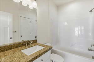 Full bath featuring vanity and shower / bath combination