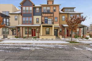 View of front facade featuring a balcony and stucco siding