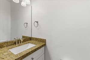 Half bath featuring vanity and toilet