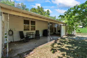 Covered patio on the side of the home.
