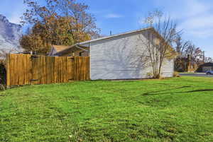 View of side of property & enclosed private backyard. Here you get to be creative with raised garden beds-plants & flowers for years to come.