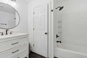 Main floor bathroom with free standing vanity-closet for storage & combo tub/shower.