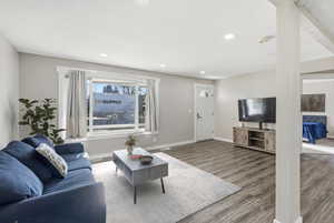 Living room with wood finished floors and recessed lighting