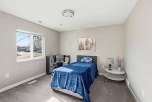 Carpeted bedroom with baseboards