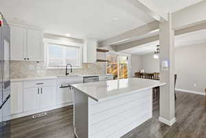 A newer kitchen less then 2 yrs old w a large island-quartz countertop-custom countertops and smart Refrigerator.