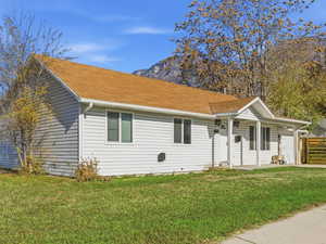 Ranch-style house featuring a porch and an attached 1 car garage. Come add your personal touch and what a view towards the east mountain bench line.