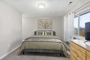 Bedroom featuring carpet floors and baseboards