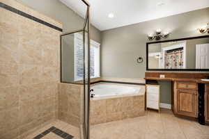Full bath with a bath, vanity, a shower stall, light tile patterned floors, and recessed lighting