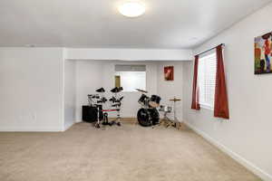 Workout area with carpet and baseboards