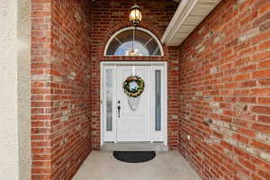 Doorway to property with brick siding