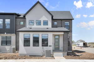View of front of property with roof with shingles and brick siding