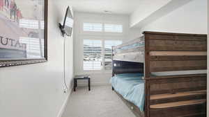 Bedroom with light carpet and baseboards