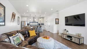 Living room featuring dark wood-type flooring and recessed lighting