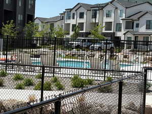 Community pool featuring a residential view and a patio
