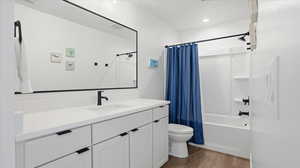 Full bathroom featuring vanity, shower / bath combination with curtain, and light wood-style flooring