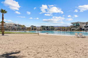 Community pool featuring a residential view and volleyball court