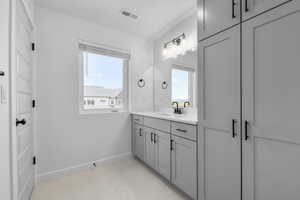 Bathroom featuring vanity and baseboards