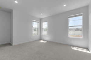 Carpeted spare room with recessed lighting