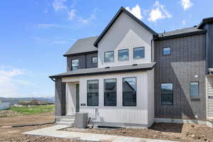 View of front facade with roof with shingles