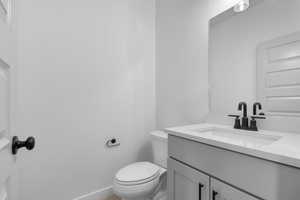 Half bath with vanity and toilet