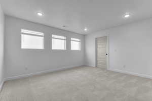 Unfurnished room with carpet flooring and recessed lighting