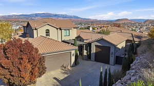 Mediterranean / spanish house featuring a residential view, stucco siding, a mountain view, and a tile roof
