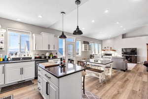 Open layout with kitchen, island, dining and family room.