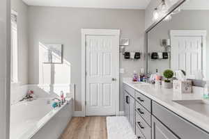 Mater bath bathroom with double vanity, a bath, separate tub & shower.