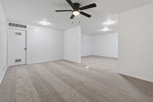 Family Room featuring light carpet, a textured ceiling, and a ceiling fan