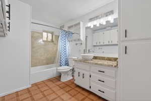 Bathroom with vanity, shower / tub combo with curtain, and light floors