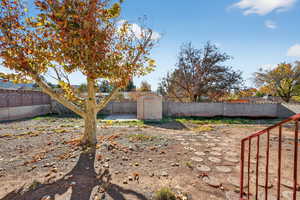 View From Kitchen Window Fenced backyard with a storage shed