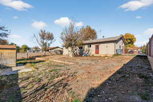 Rear view of property with a storage unit and RV Parking