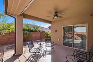 Fenced backyard featuring a patio area and ceiling fan