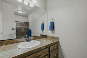 Bathroom featuring vanity and a tile shower
