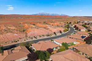 Aerial view of property and surrounding area featuring nearby suburban area