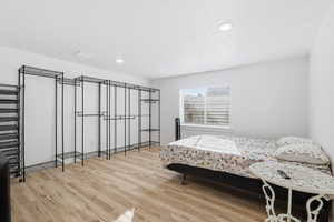 Bedroom featuring light wood-type flooring and recessed lighting