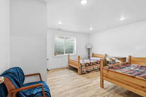 Bedroom with light wood-style flooring and recessed lighting
