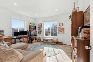 Home office featuring light wood-style floors and recessed lighting