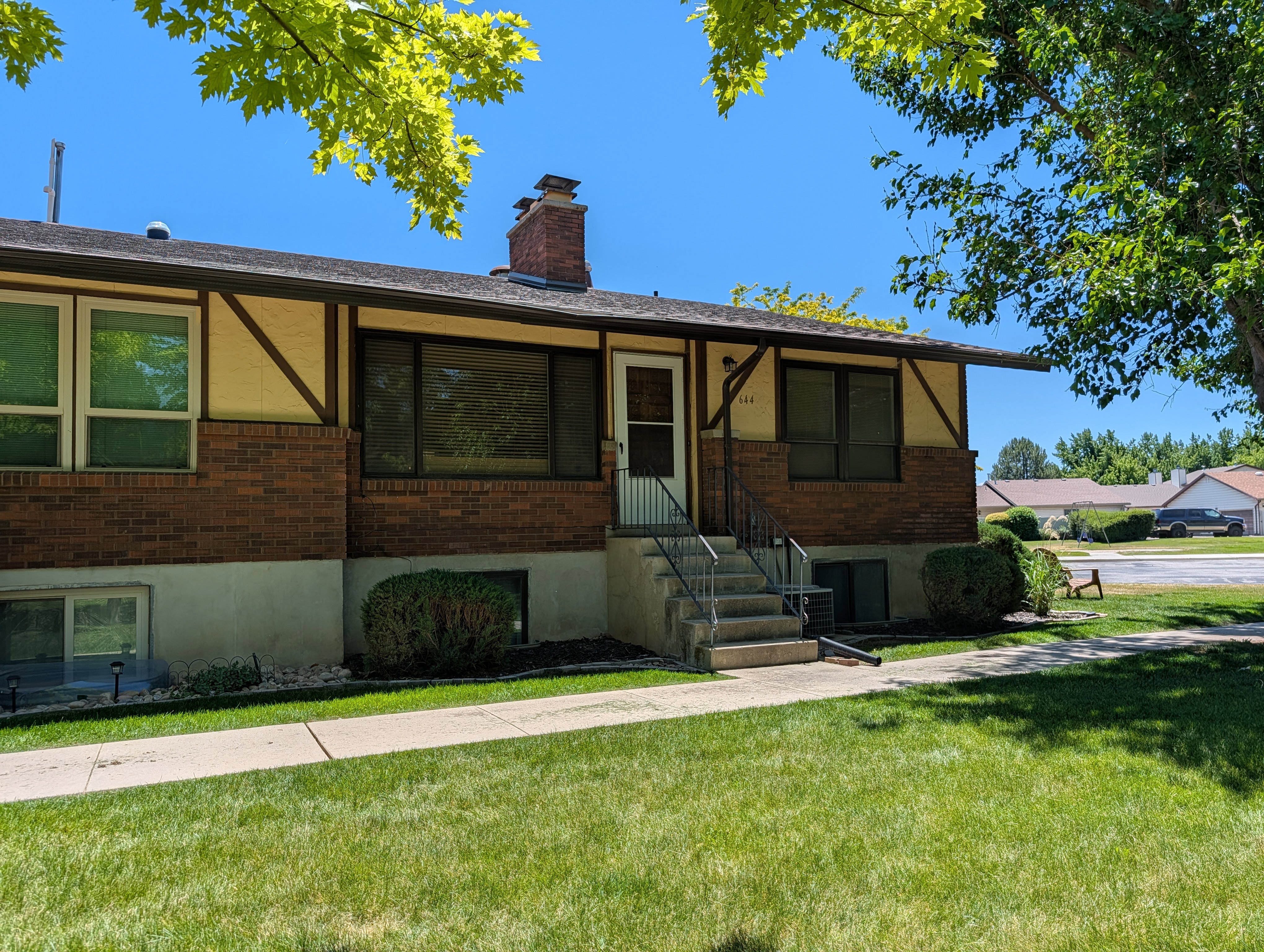 Split-level residence featuring brick and stucco siding