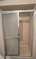 Full bath featuring tiled shower