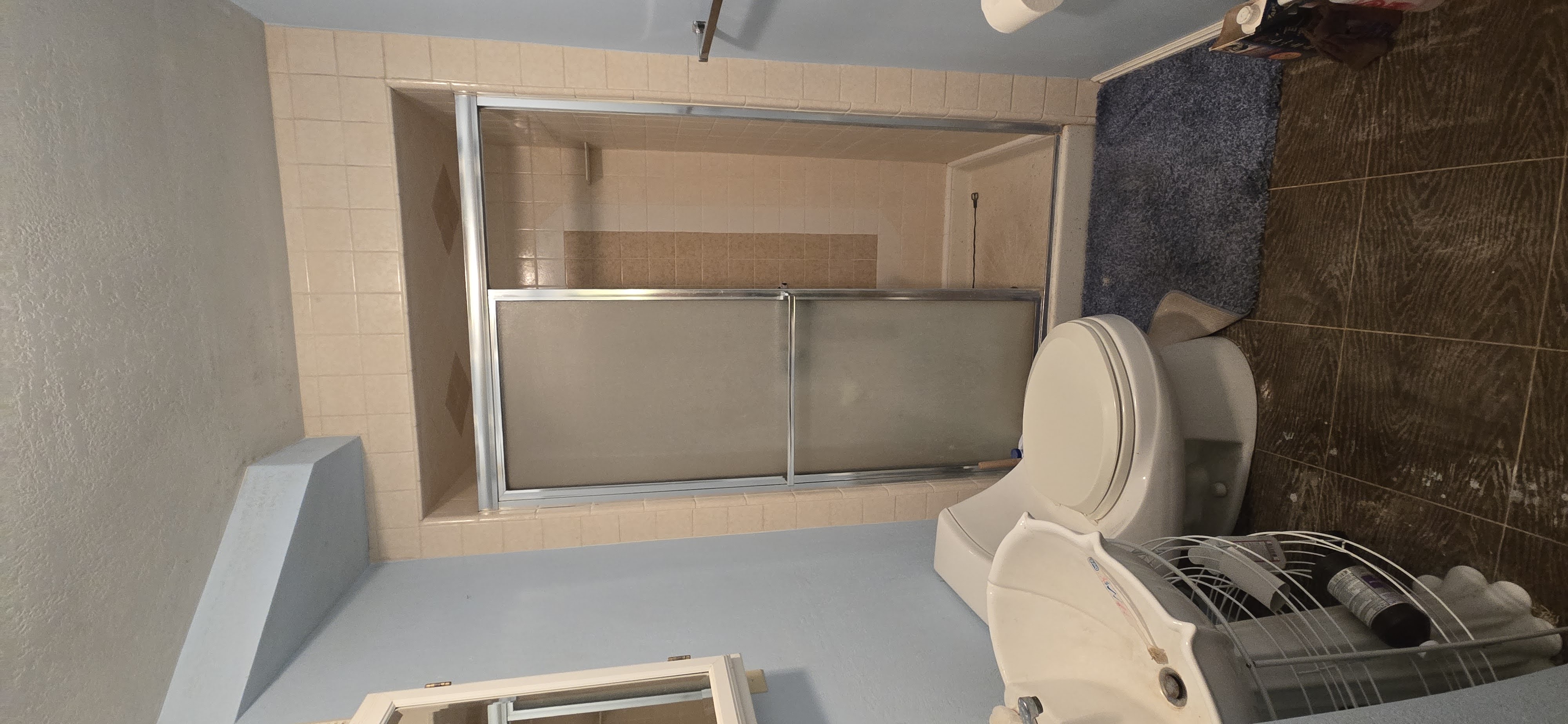 Bathroom 1 with a stall shower and a textured ceiling