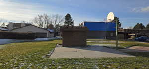 View of home's community featuring a yard and Basketball Standard