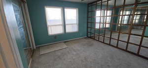 Empty room featuring carpet and baseboards